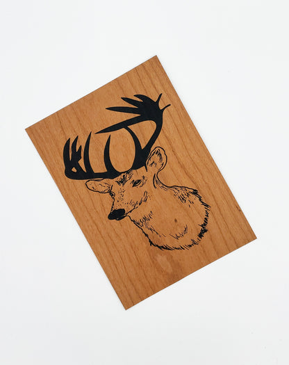 Wood veneer prints featuring hand printed deer, on a white background
