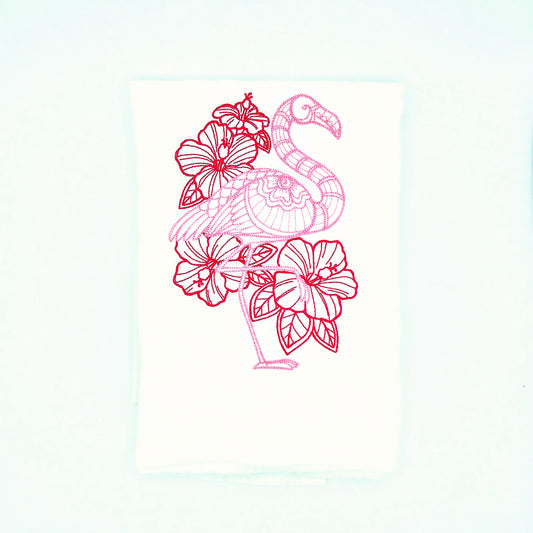 pink flamingo and flowers embroidered on a flour sack tea towel, against a white background